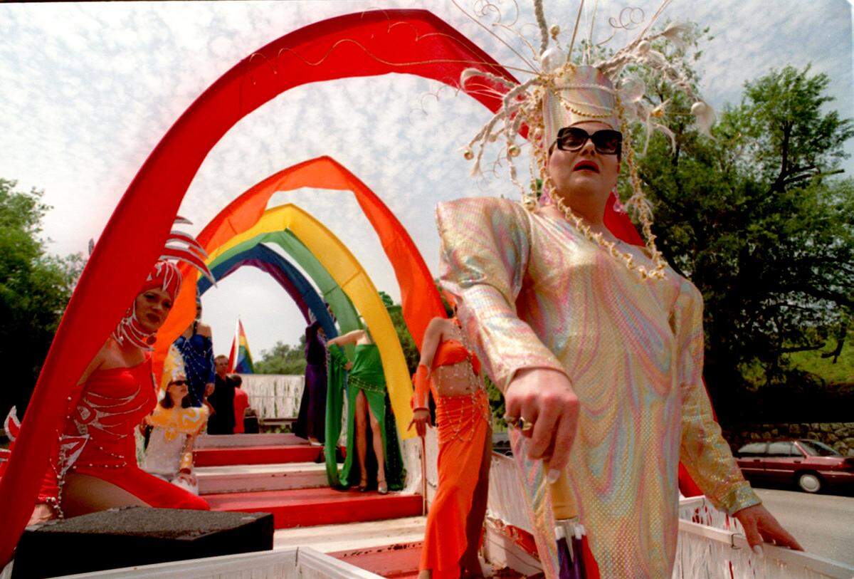 Twyla Zone stands atop a float on Main Street as Pride Fest ’99 begins with a parade in downtown Kansas City, Missouri. Hundreds gathered to watch the parade, and a festival later in the day that attracted more than 3,000 people.