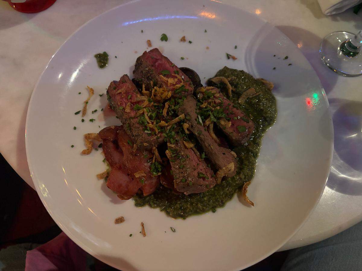 Medium-rare strip steak, smashed potatoes and pepita pesto are served at Tom’s Town in the Crossroads.
