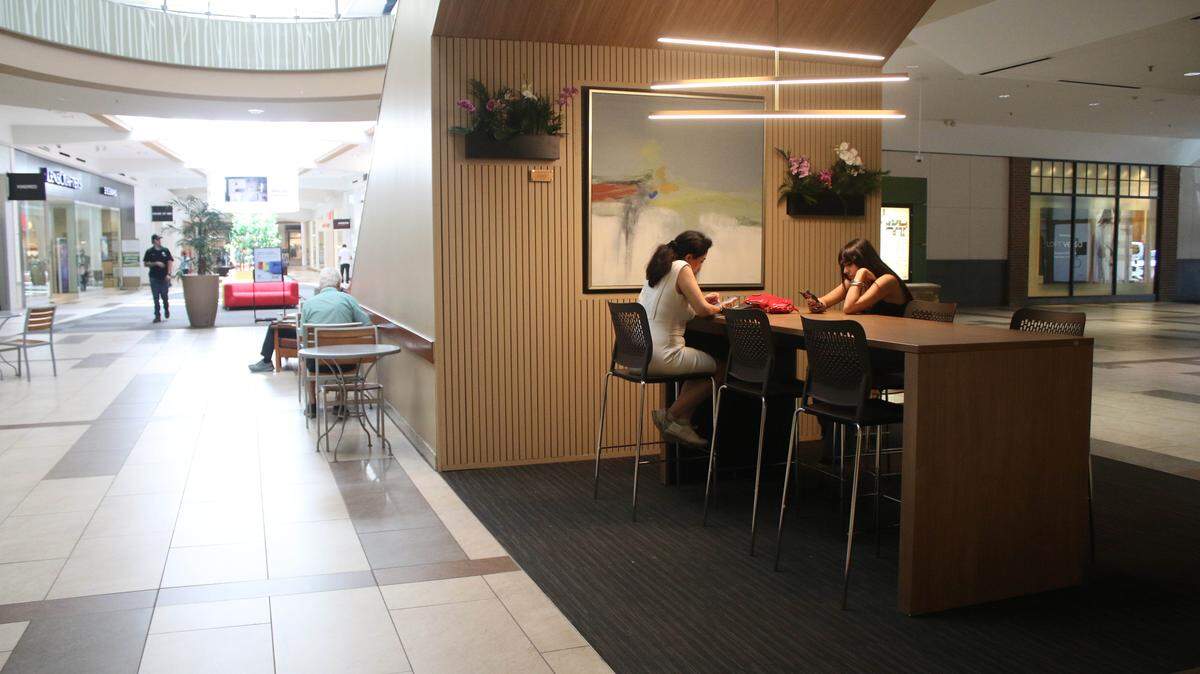 Topeka residents Sara Eftekharnia and Andia Najarchi relax at the newly-redesigned space near Nordstrom at Oak Park Mall. Students from an interior design class at Shawnee Mission Northwest took on the project last semester.