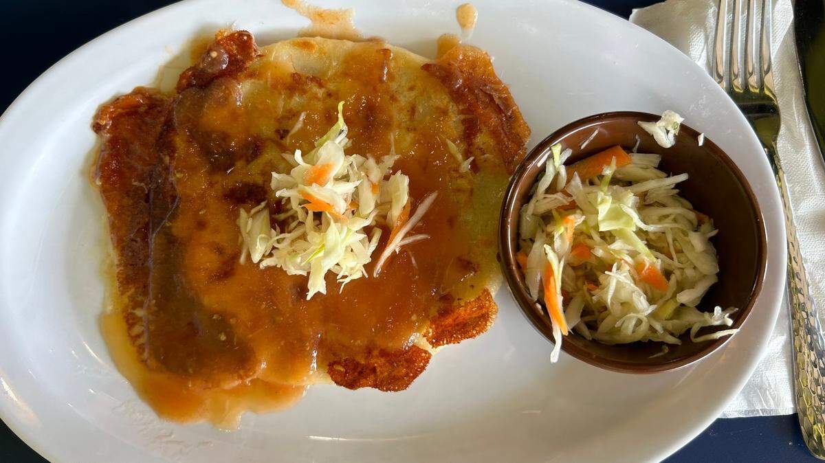 La Cocina de Mary serves pupusas, a popular Salvadoran dish that consists of cheese-filled cake drizzled in salsa and topped with curtido, which is like coleslaw.