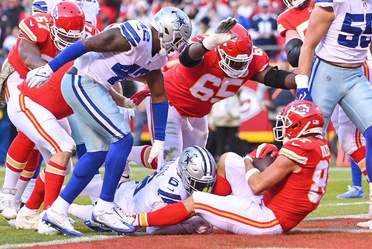 Kansas City Chiefs tight end Travis Kelce backs into the endzone on a run for a touchdown in the first quarter against the Dallas Cowboys Sunday, November 21, 2021, at Arrowhead Stadium. The Chiefs were in the wildcat formation when Kelce took the snap and ran it in on short yardage.