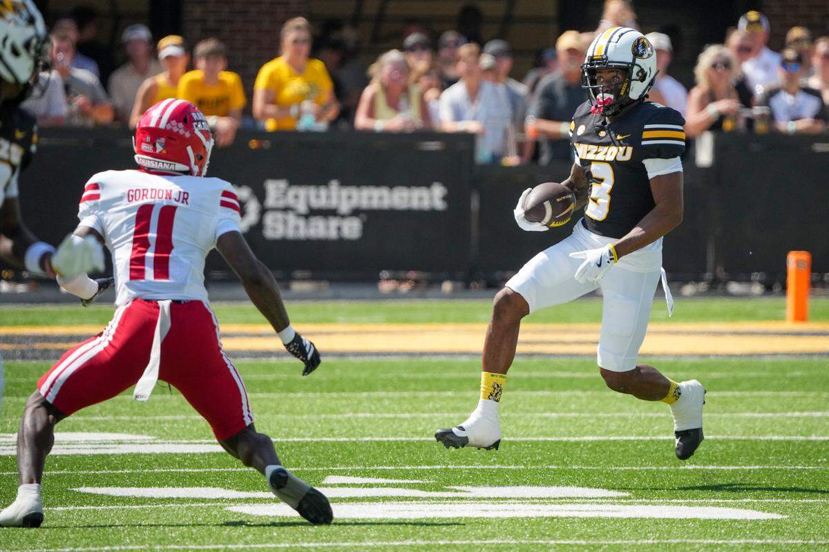 Missouri Tigers wide receiver Kevin Coleman Jr. (3) runs the ball as Louisiana-Lafayette Ragin’ Cajuns defensive back Brent Gordon Jr. (11) defends during the first half of the game at Faurot Field at Memorial Stadium on Sept. 13, 2025.