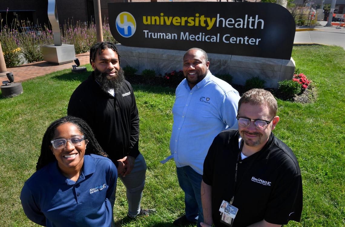The staff of the the Aim4Peace program is a small one. From left, Lia Thompson, hospital case manager, Marquell Harris, hospital responder, Rashid Junaid, program manager, and Martin Atwell, social support supervisor, help operate the program.