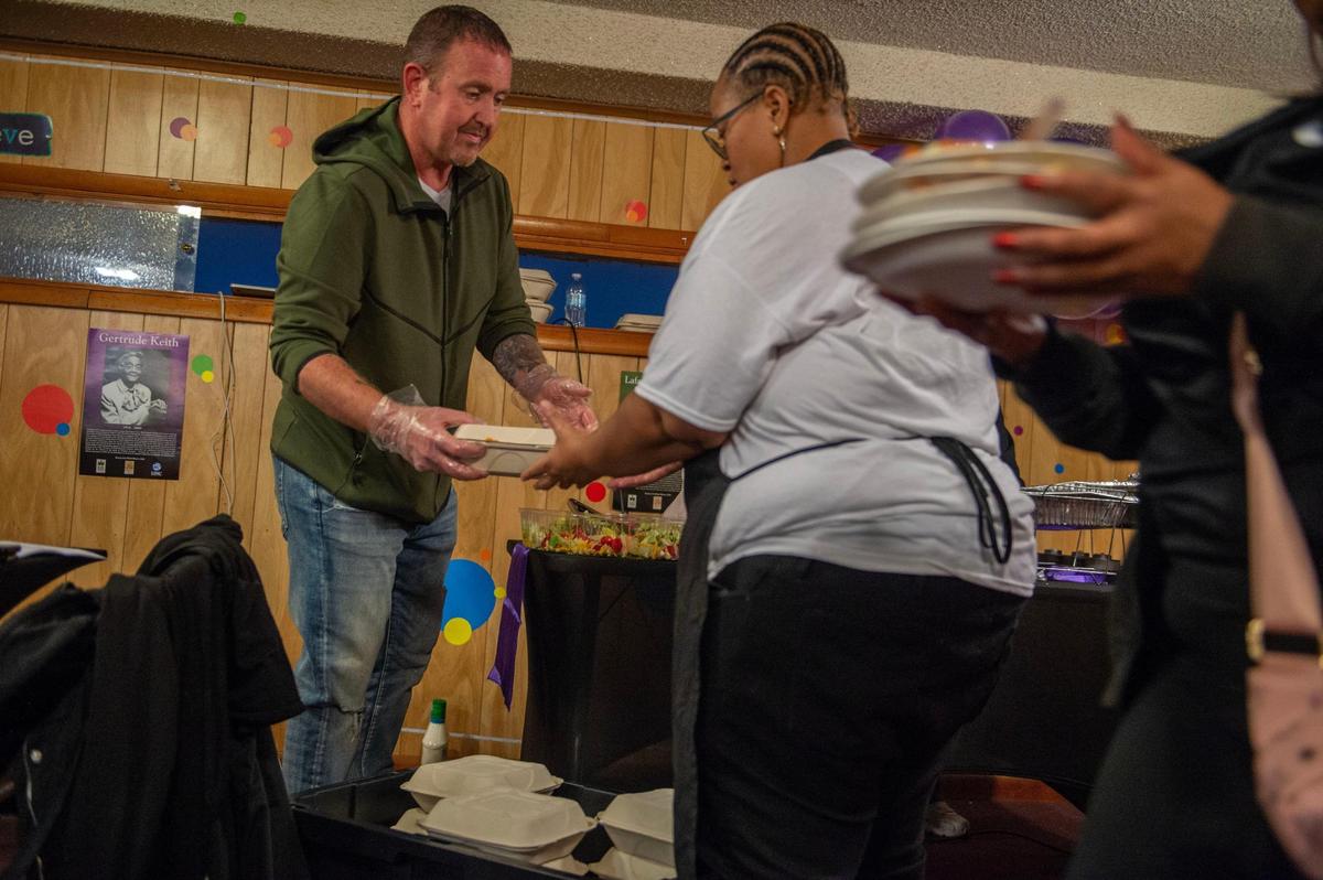 Church volunteer Cobey Cooper, left, and Lannie Smith, owner of Kommon Centz Catering, box up meals before heading out to deliver them to the homeless living on the streets.