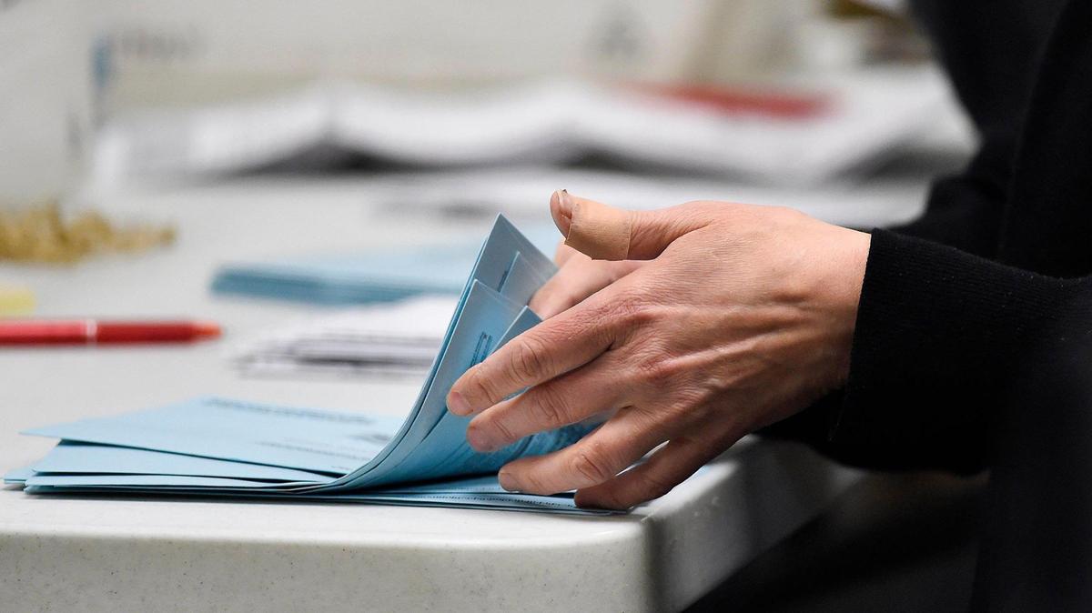 An election worker counts envelopes of mail-in ballots at the Johnson County Election Office in Olathe in 2020.