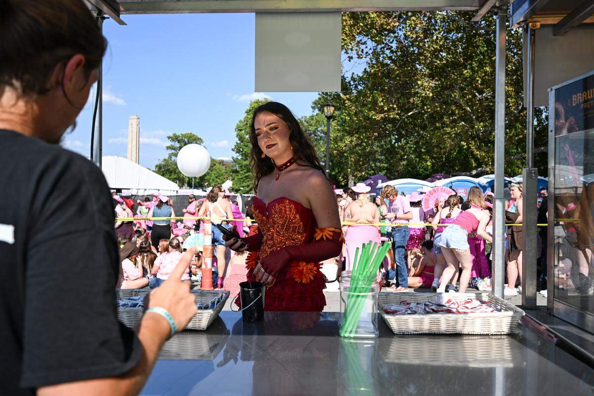 Allei Seivert grabs some food from a vendor before the Chappell Roan Concert on Friday, Oct. 3, 2025, at the National WWI Museum and Memorial.