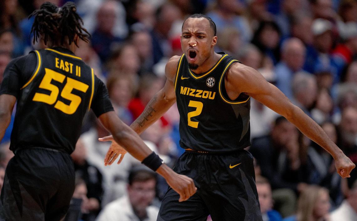 Missouri Tigers guard Tamar Bates (2) celebrates a 3-pointer with guard Sean East II (55) during an NCAA basketball game against the Kansas Jayhawks on Saturday, Dec. 9, 2023, in Lawrence, Kan.