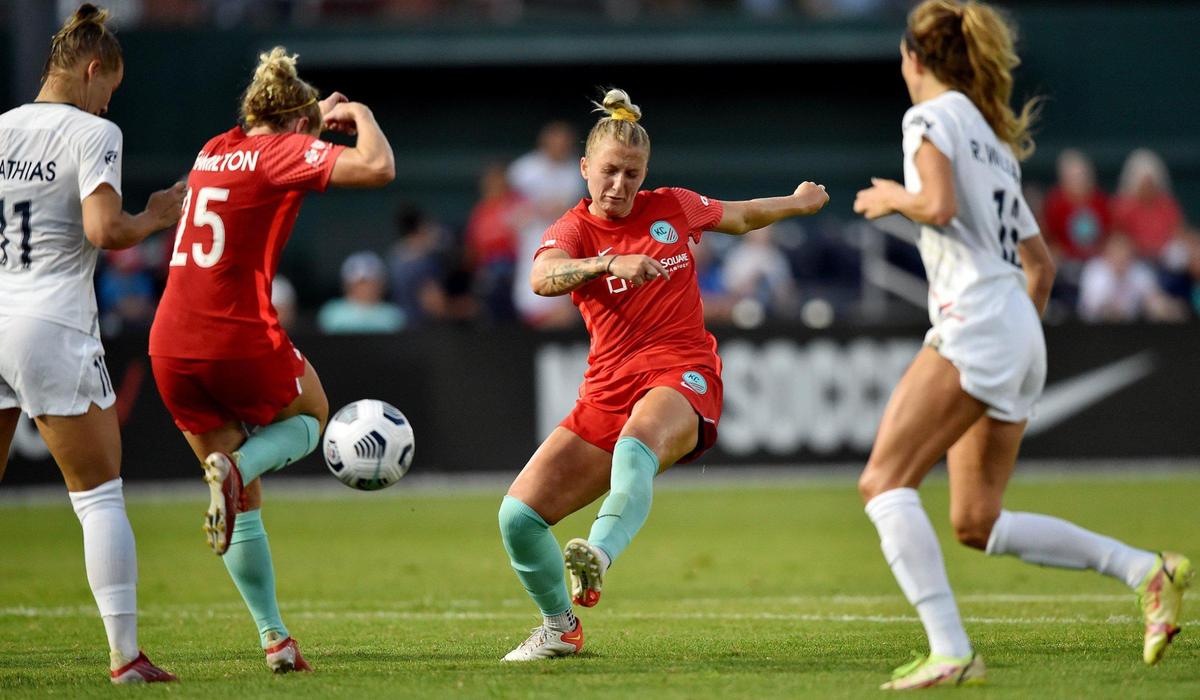 KC NWSL’s Kristen Hamilton tries to move out of the way as fellow KC forward Hailie Mace takes a shot in the second half of a game earlier this season against the North Carolina Courage at Legends Field in Kansas City, Kan.