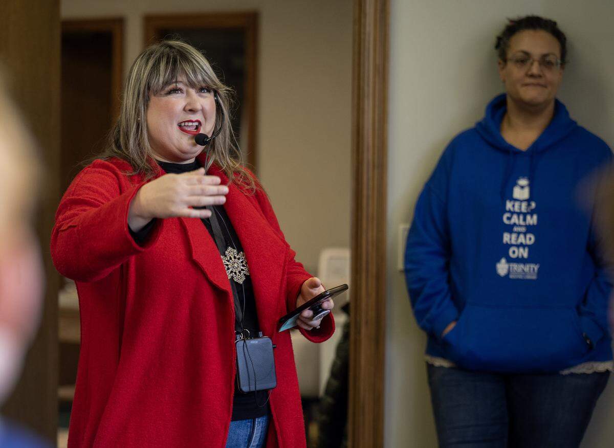 Music teacher Rachel Marlow of Central Elementary School in Olathe, directions students in the special chorus as they sing Christmas carols during a visit to the Trinity Fellowship Church office in Downtown Olathe on Wednesday, Dec. 17, 2025.