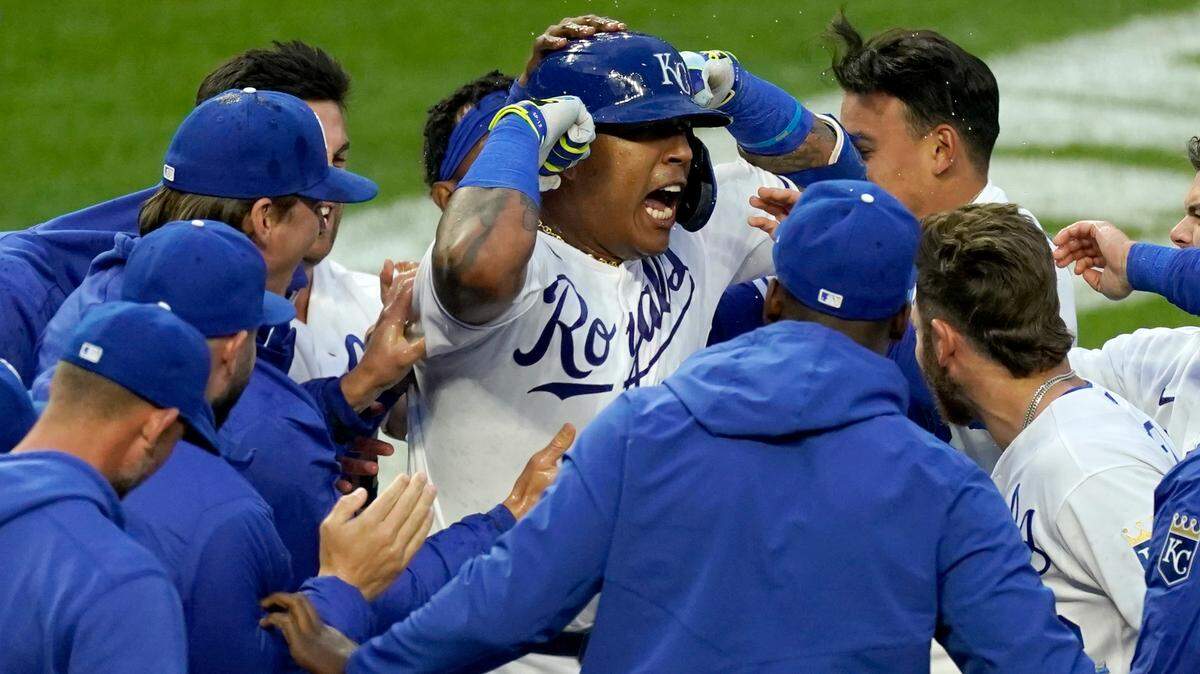 Kansas City Royals’ Salvador Perez, center, celebrates with teammates after hitting a walkoff home run during the seventh inning of the second baseball game of the team’s doubleheader against the Toronto Blue Jays on Saturday, April 17, 2021, in Kansas City, Mo. The Royals won 3-2. (AP Photo/Charlie Riedel)