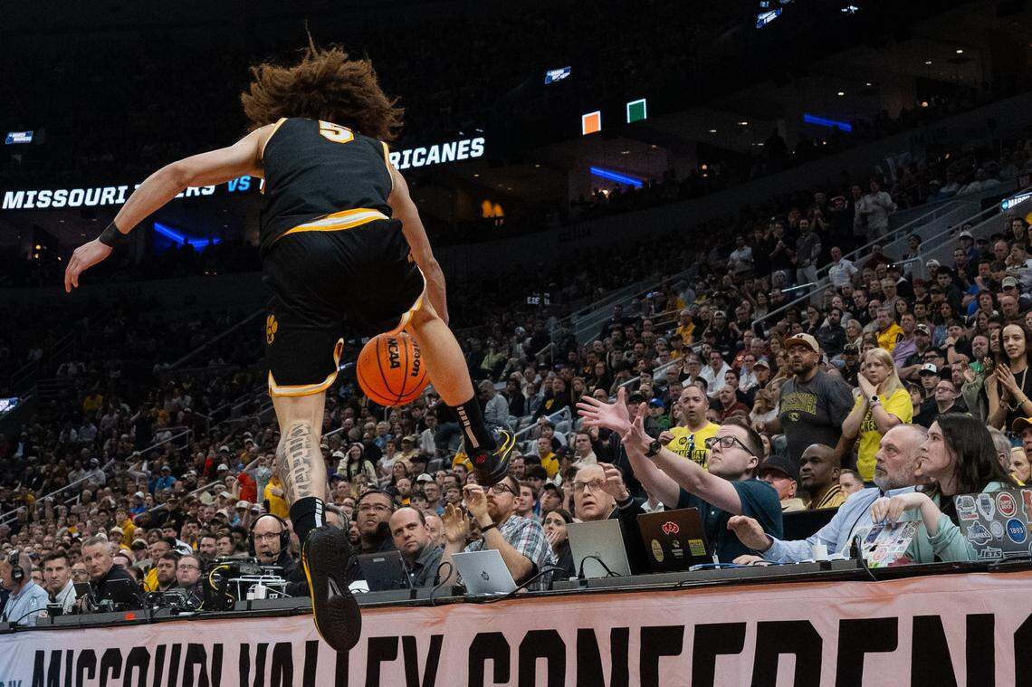 Missouri Tigers guard T.O. Barrett (5) jumps over the scorers table in the first half of the Tigers first-round NCAA Tournament matchup vs. the Miami Hurricanes at Enterprise Center in St. Louis on Friday, March 20, 2026.