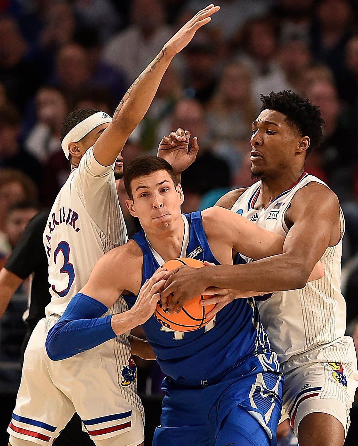 KU’s Dajuan Harris, left, and David McCormack double up Creighton’s Trey Hawkins during the second half of the Jayhawks’ 79-72 win over the Bluejays in a second-round game of the NCAA Tournament in Fort Worth.