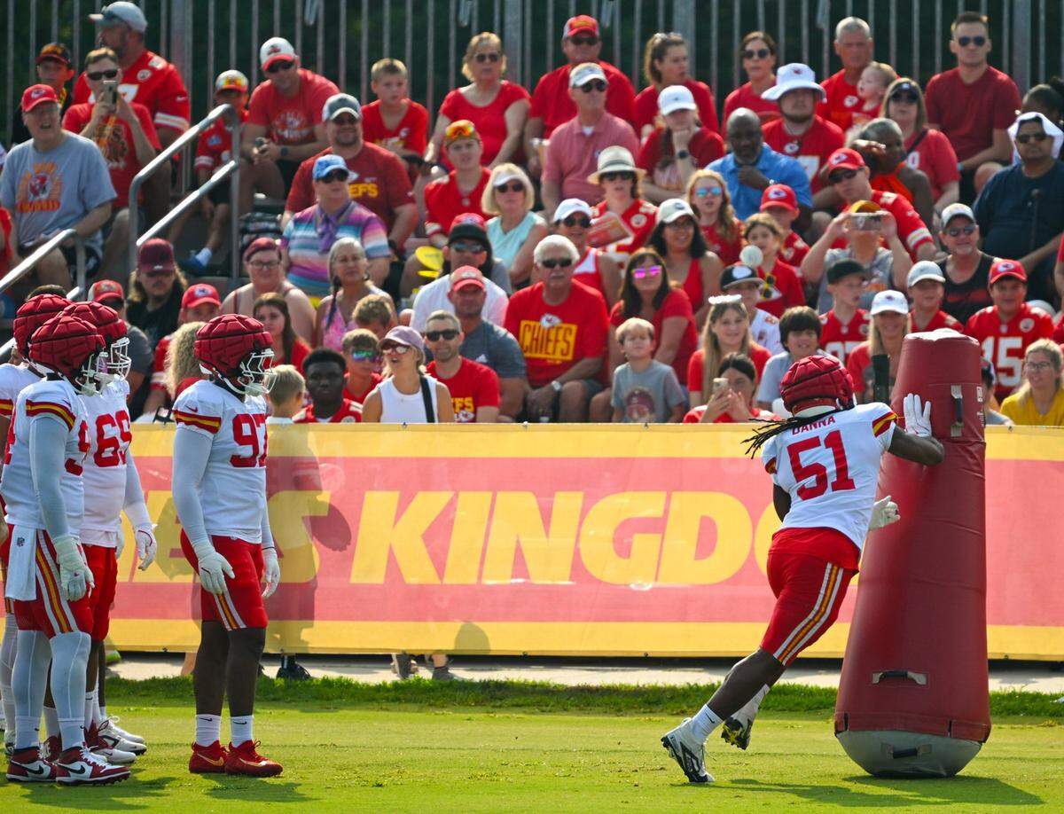 Fans watch Chiefs defensive end Mike Danna (51) run a drill during training camp at Missouri Western State University in St. Joseph.
