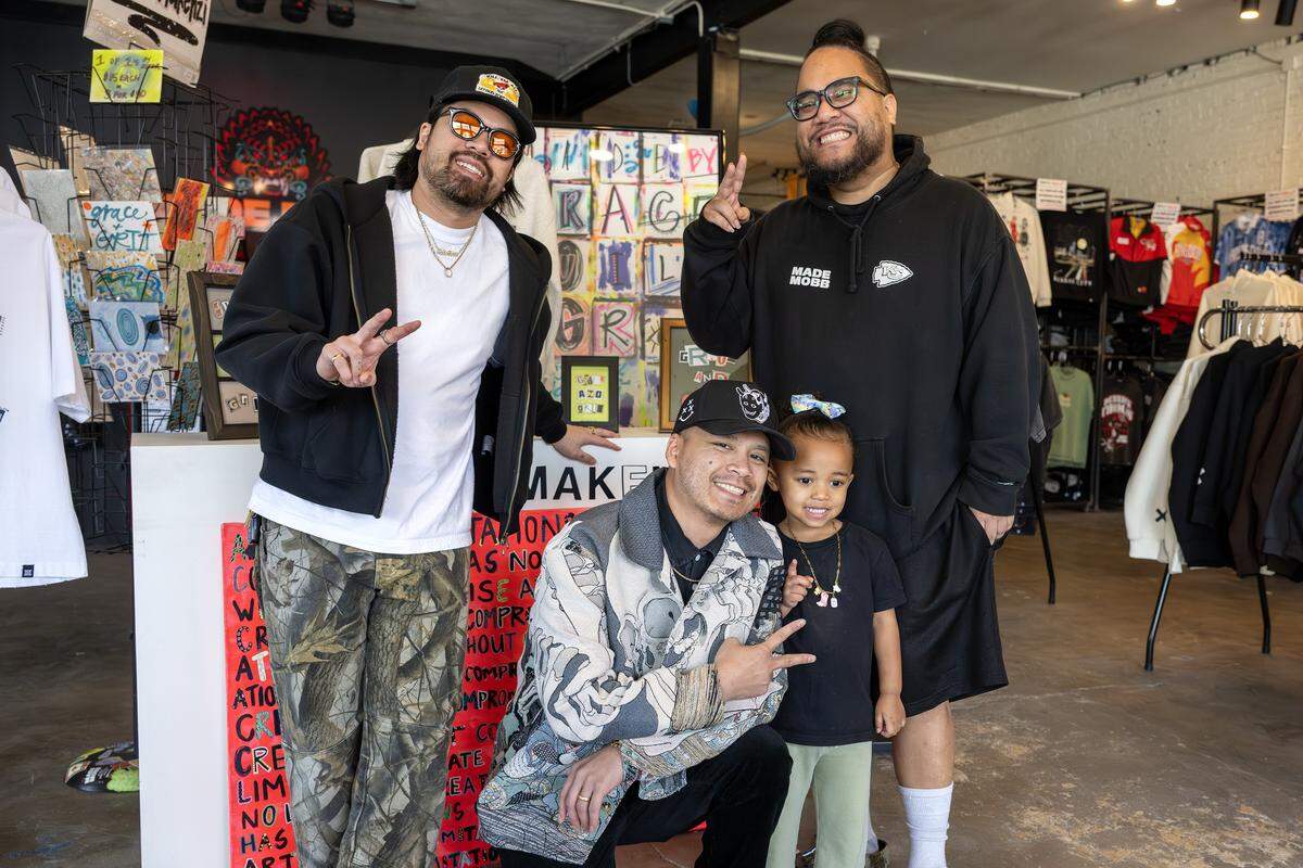 Vu Radley, left, Jesse Phouangphet and Mark Launiu, owners of Made Mobb, pose for a portrait with Launiu's daughter on Wednesday, March 18, 2026, in Kansas City.
