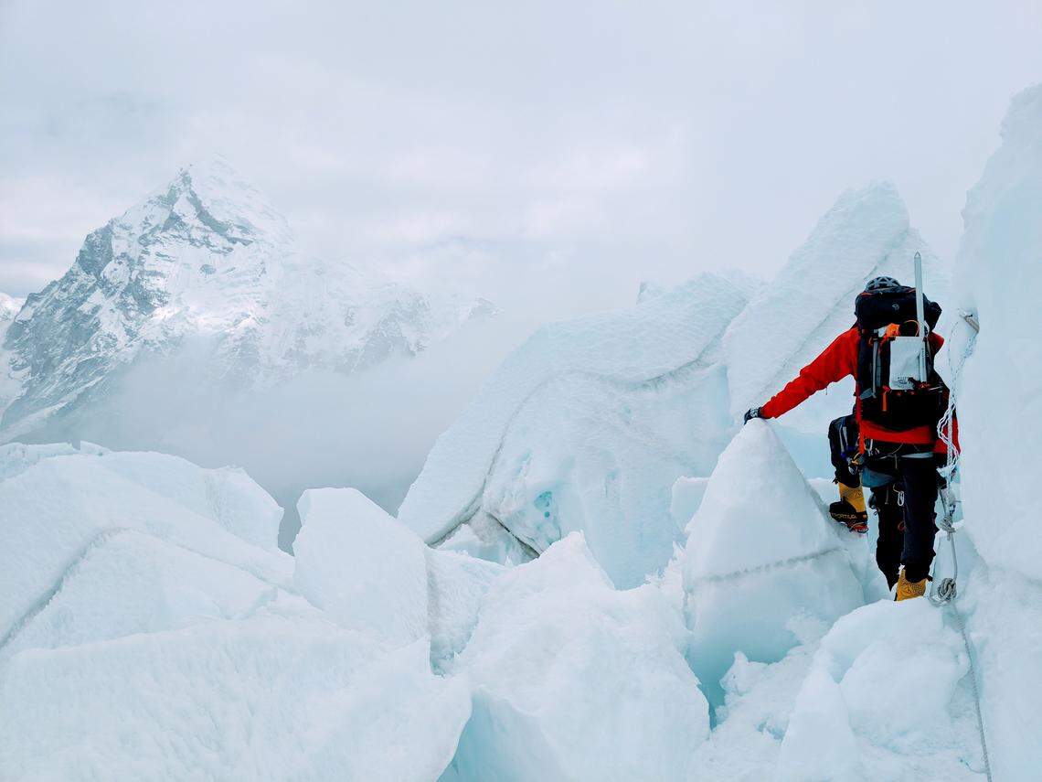 Becker’s climbing partner, Daniel Wehrly, looks out over the nearby peak of Pumari.