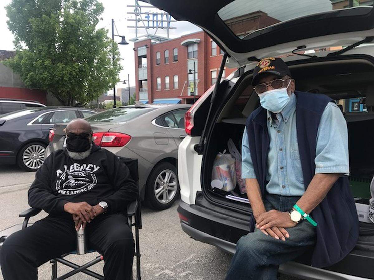 “I don’t care what opens up, I’m not going in. I’m not going in anyplace,” said Craig T. Watson, 69, left, sitting with friend Archie Welch, 79, at 18th and Vine streets. Both think masks are vital to preventing the spread of coronavirus.