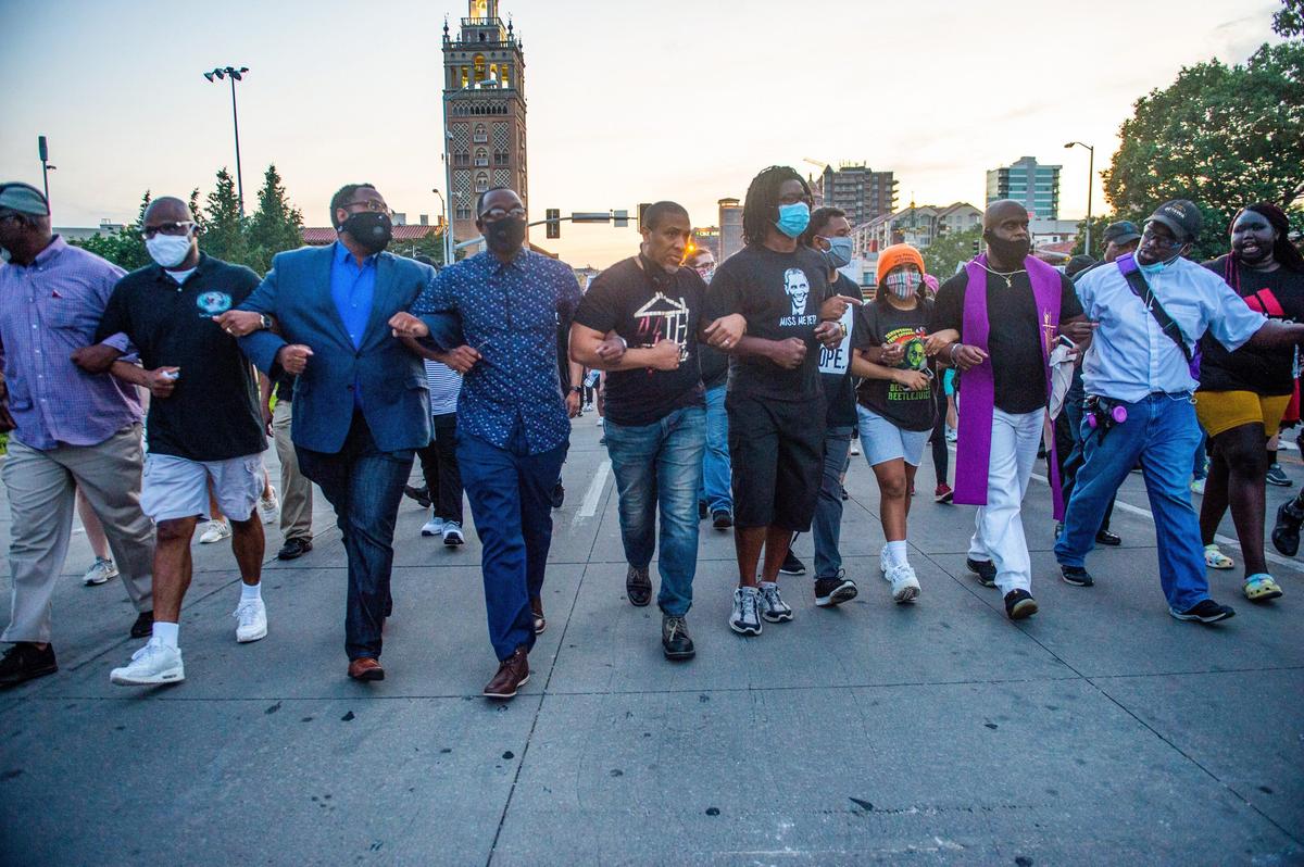 Religious leaders joined the protesters Tuesday at the George Floyd protest at the Country Club Plaza where they locked arms and marched down the street together.