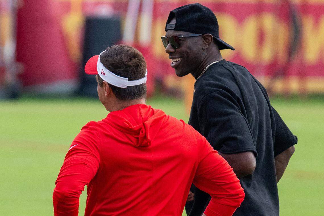 Former NFL wide receiver Terrell Owens talks with Chiefs general manager Brett Veach at Chiefs Training Camp on Thursday, Aug. 7, 2025 in St. Joseph. Owens, who played for head coach Andy Reid when he coached the Philadelphia Eagles, attended training camp and interacted with several players and coaches.