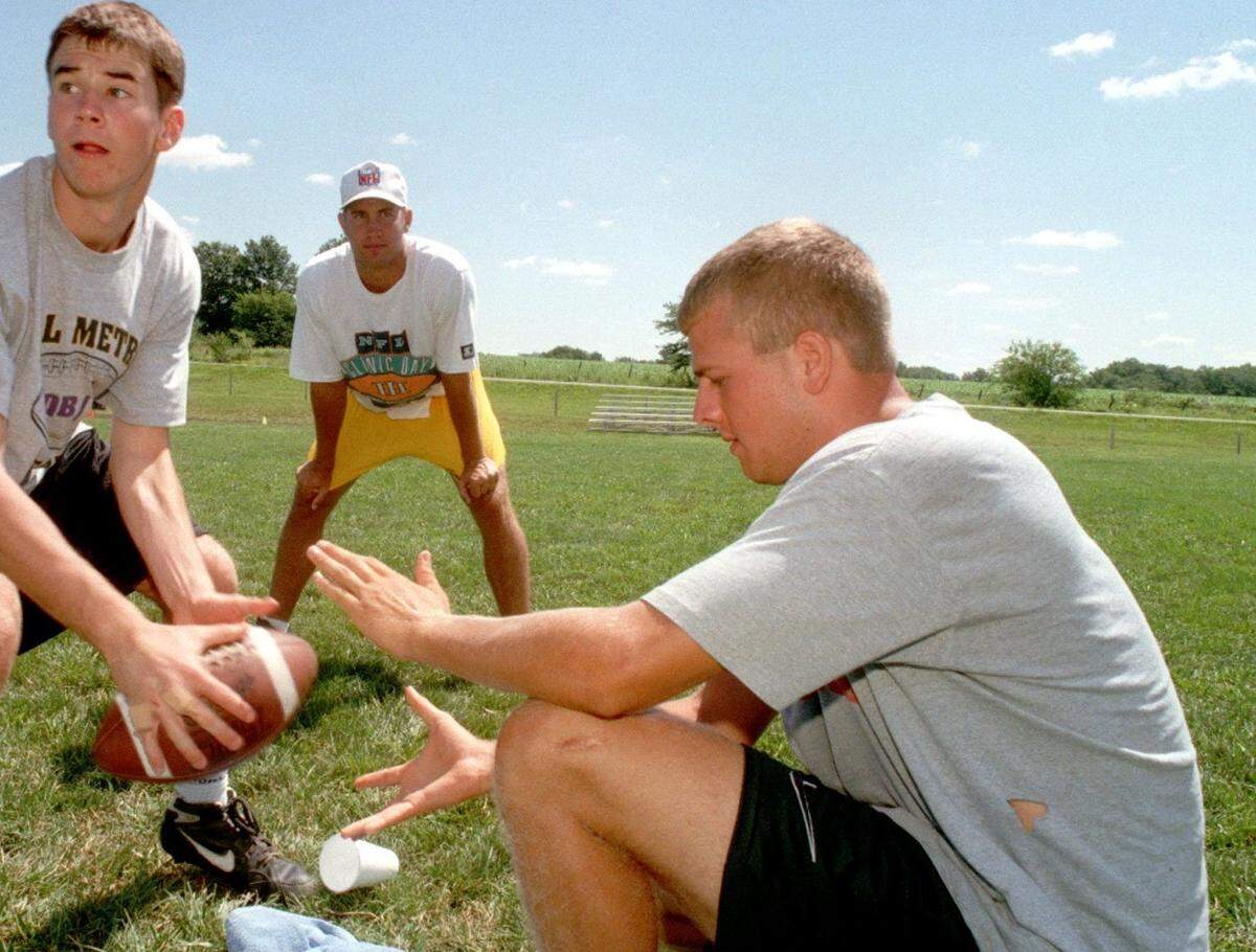Brian Schottenheimer, right, who at the time this photo was snapped in 1996 was about to be a Florida Gators senior, works with a young quarterback at a camp in KC.