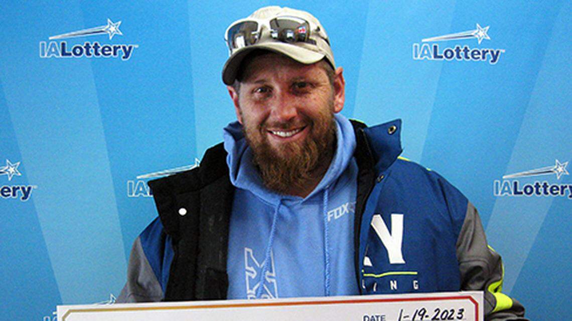 Travis Hovey with his $100,000 check.