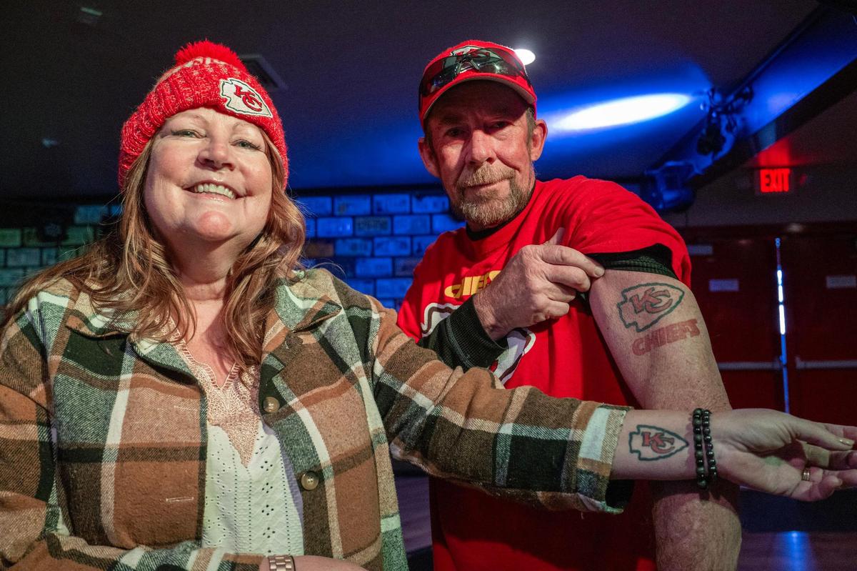 Jane Jernigan, left, and her husband Dan, both Kansas City Chiefs fans, showcase their matching Kansas City Chiefs logo tattoos at the Local Brew House on Wednesday, Feb. 7, 2024, in Albuquerque, N.M. The Jernigans are active members of the Facebook group called Chiefs Kingdom New Mexico chapter.