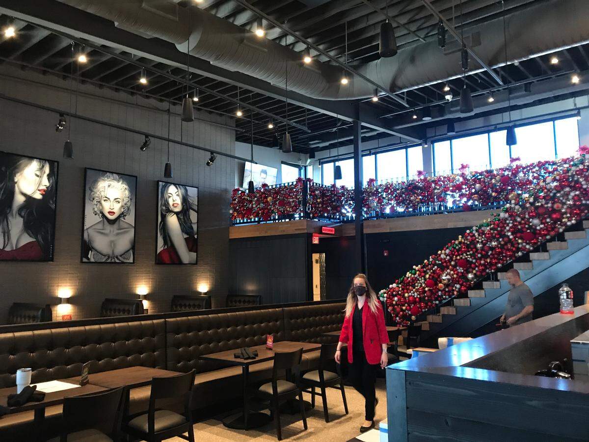 The new Red Door design features a private upstairs dining room, second story mezzanine, open kitchen and patio overlooking a pond.