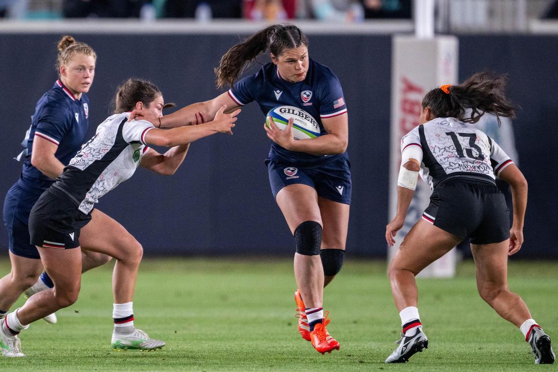 Team USA player Ilona Maher stiff-arms a Canadian player while running with the ball during the USA vs. Canada rugby match at CPKC Stadium on Friday, May 2, 2025. Canada won the match 26-14.