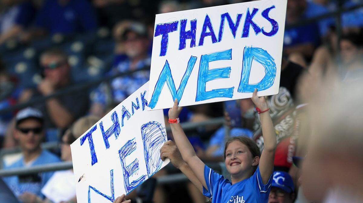 Fans hold signs honoring Kansas City Royals manager Ned Yost during the sixth inning of a baseball game against the Minnesota Twins at Kauffman Stadium in Kansas City, Mo., Sunday, Sept. 29, 2019. (AP Photo/Orlin Wagner)