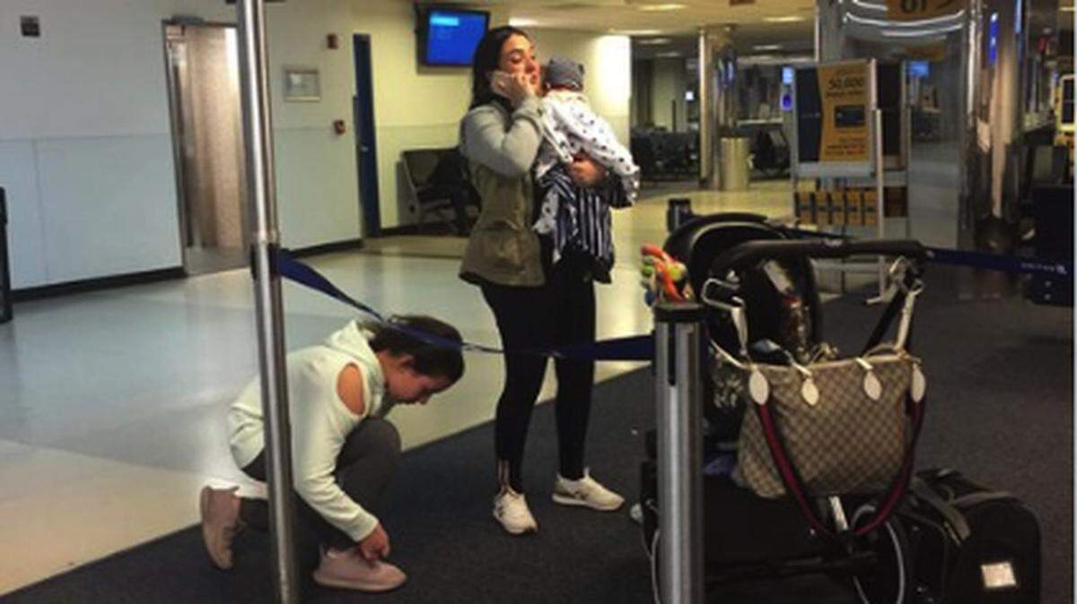 United Airlines has apologized after a French bulldog was placed in an overhead bin on a three-hour flight Monday from Houston to New York, and died. A passenger took this photo of the dog's owner and family.
