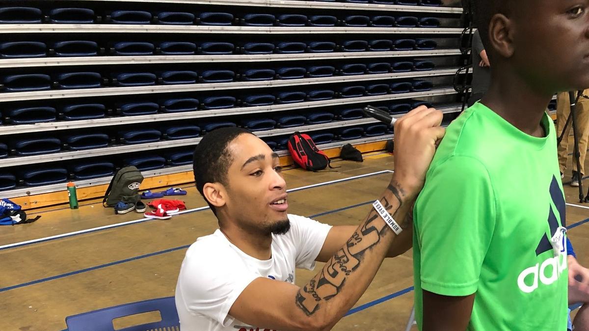 Kansas guard Dajuan Harris signs for a camper during Washburn basketball camp on Tuesday, June 15, 2021, in Topeka, Kansas.
