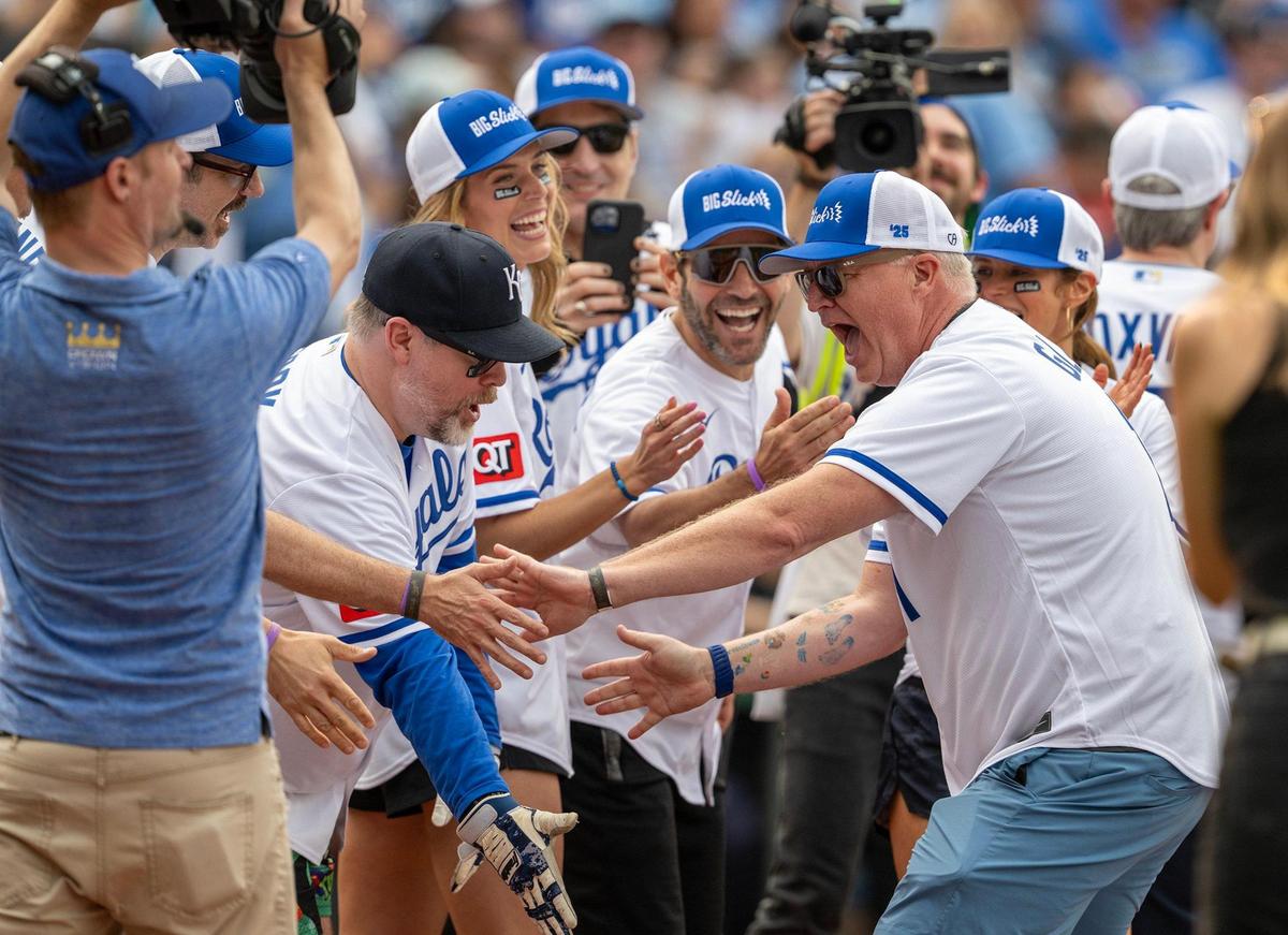 Bill Glass, actor, right, celebrates a homer run with his teammates during the Big Slick Celebrity Softball game on Friday, May 30, 2025, at Kauffman Stadium in Kansas City.