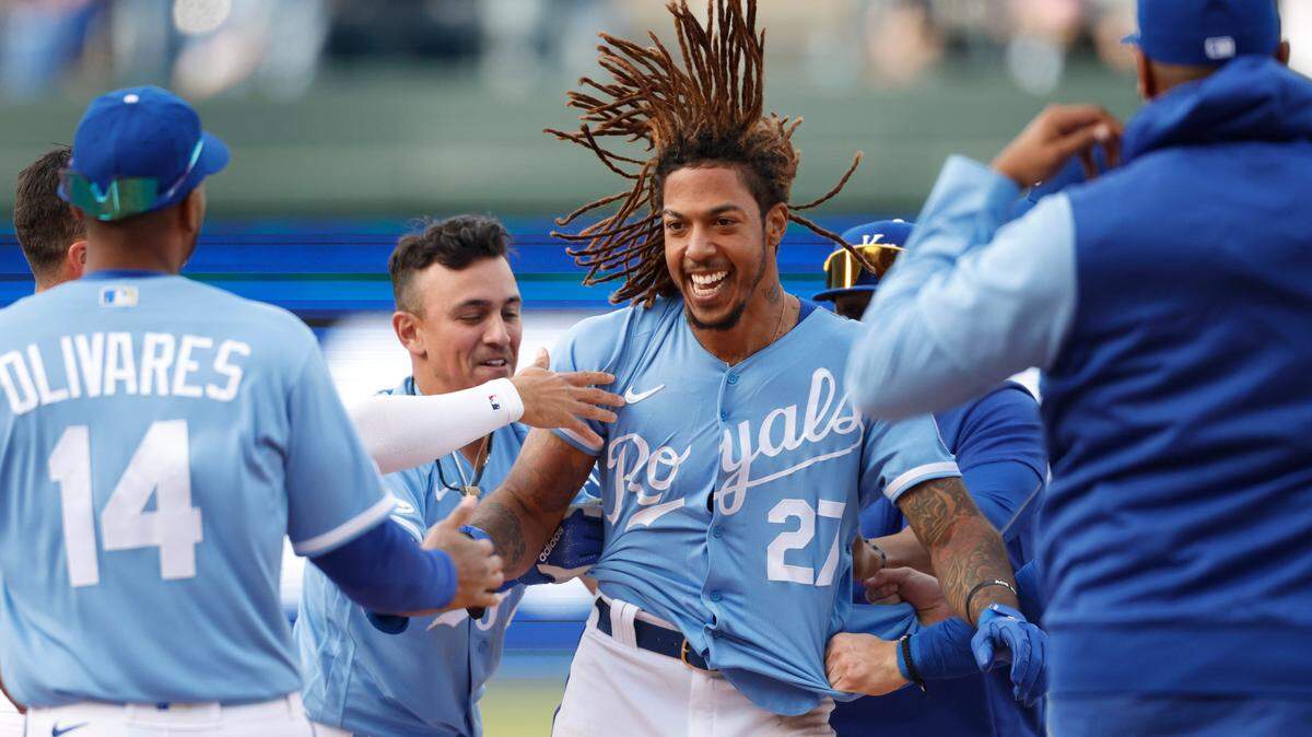 The Kansas City Royals’ Adalberto Mondesi (27) celebrates with his teammates after he batted in the game-winning run during the 10th inning against the Cleveland Guardians in Kansas City, Mo., Saturday, April. 9, 2022.