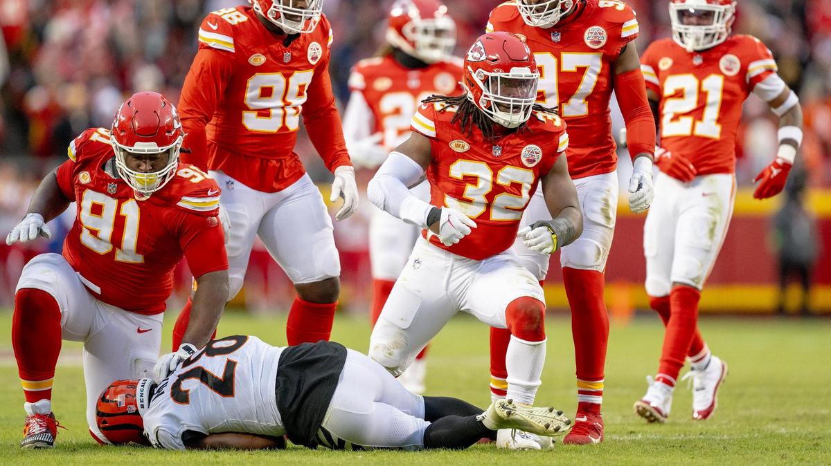 Kansas City Chiefs linebacker Nick Bolton (32) celebrates a defensive tackle on Cincinnati Bengals running back Joe Mixon (28) during an NFL football game at GEHA Field at Arrowhead Stadium on Sunday, Dec. 31, 2023, in Kansas City.