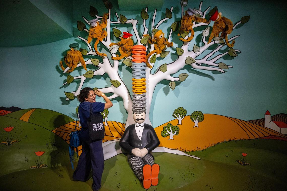 Monkeys wave to book editor Rachel Davis of Kansas City in the “Caps for Sale” exhibit at The Rabbit hOle in March.