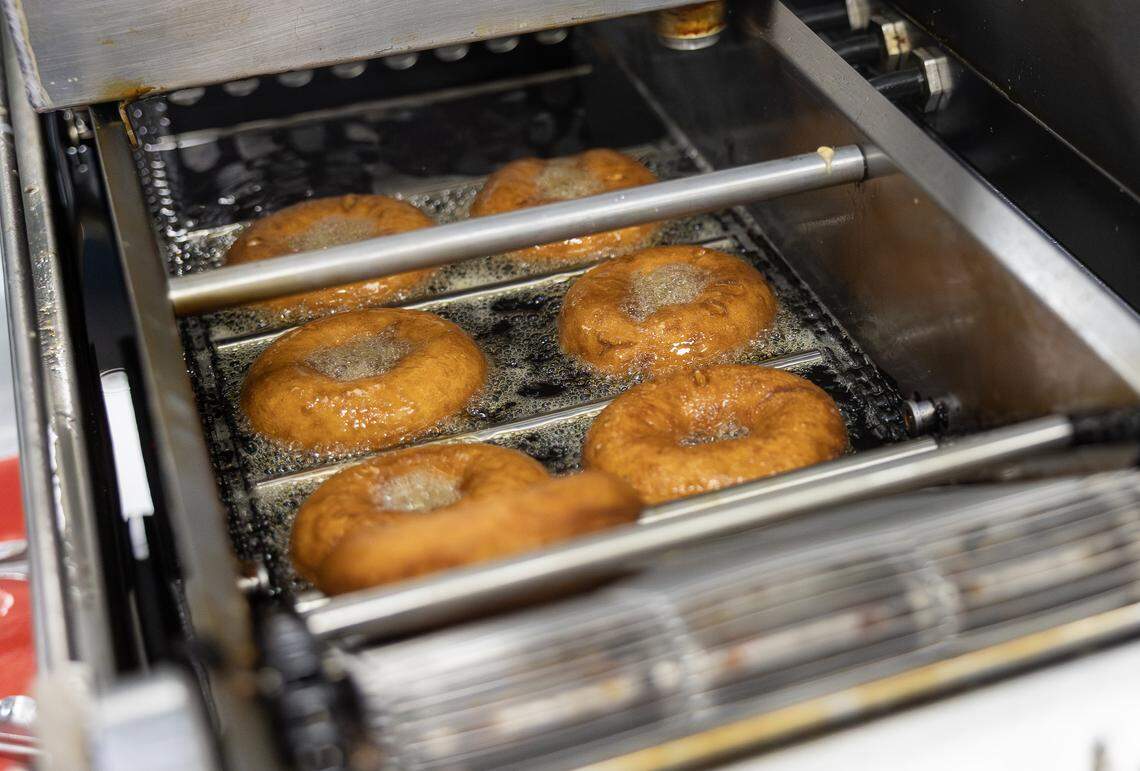 A batch of donuts fry in a fryer in the Duck Donuts Shop in Lee’s Summit on Thursday, April 23.