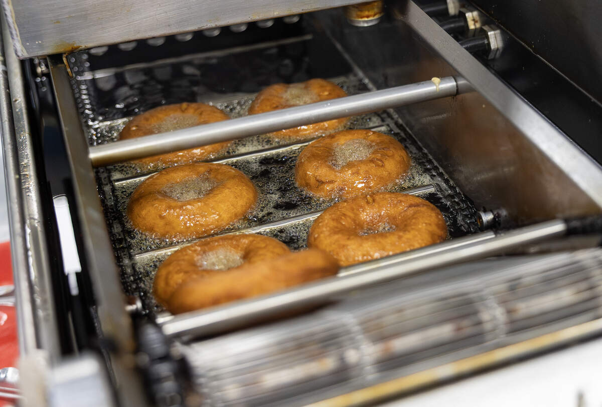 A batch of donuts fry in a fryer in the Duck Donuts Shop in Lee’s Summit on Thursday, April 23.