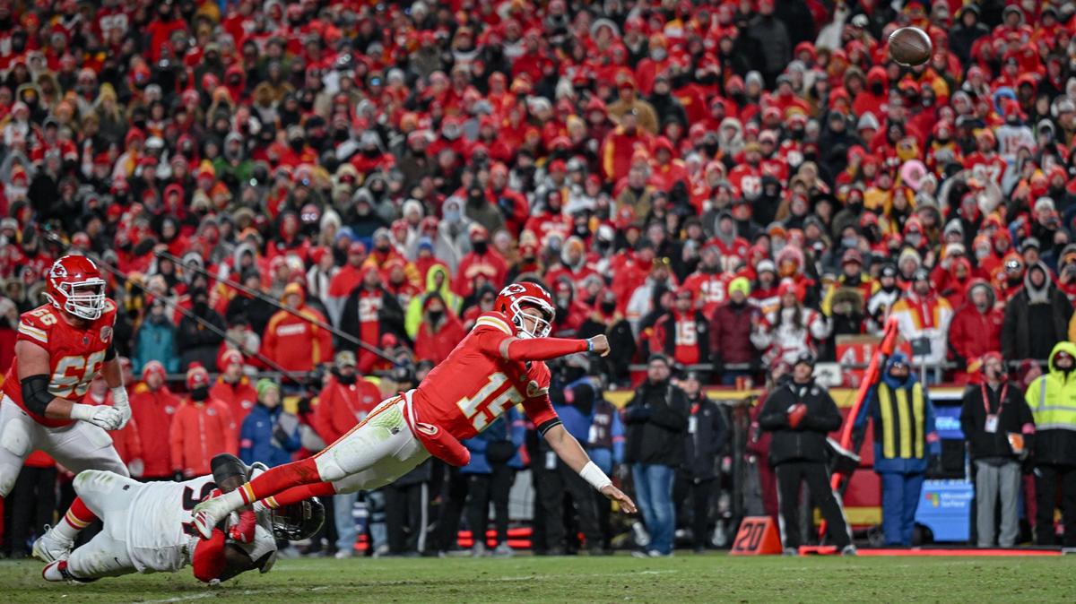 Kansas City Chiefs’ Patrick Mahomes (15) goes down in the grasp of Houston Texans defensive tackle Mario Edwards Jr. while he throws a touchdown pass to tight end Travis Kelce in the fourth quarter during the AFC Divisional Round playoff game on Saturday, Jan. 18, 2025, at GEHA Field at Arrowhead Stadium.