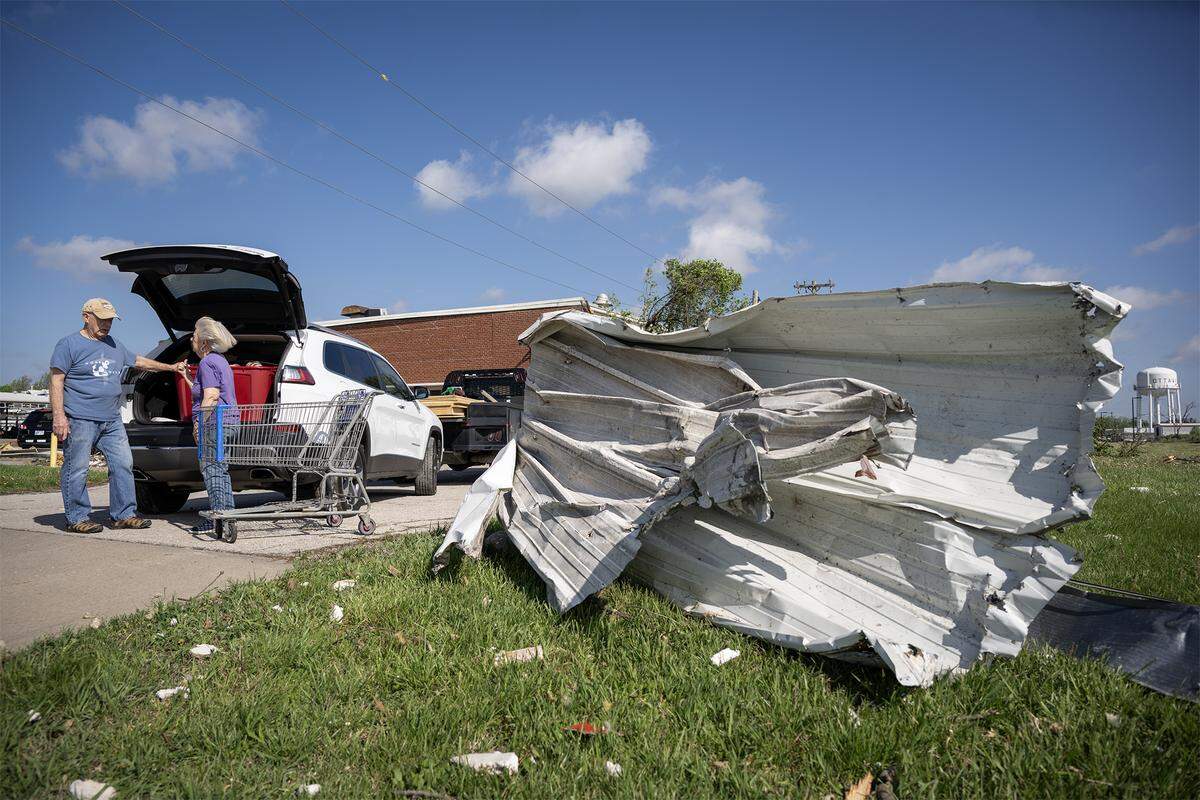 Roger Carson and Janet Slifer moved perishable items from Hope House, a not-for-profit food pantry, in Franklin County, Kansas, on Tuesday, April 14, 2026, in Ottawa, Kansas. A tornado struck the facility Monday night and damage the building. Slifer, the board president, said the food items will be distributed among self-serve food boxes in the city. 