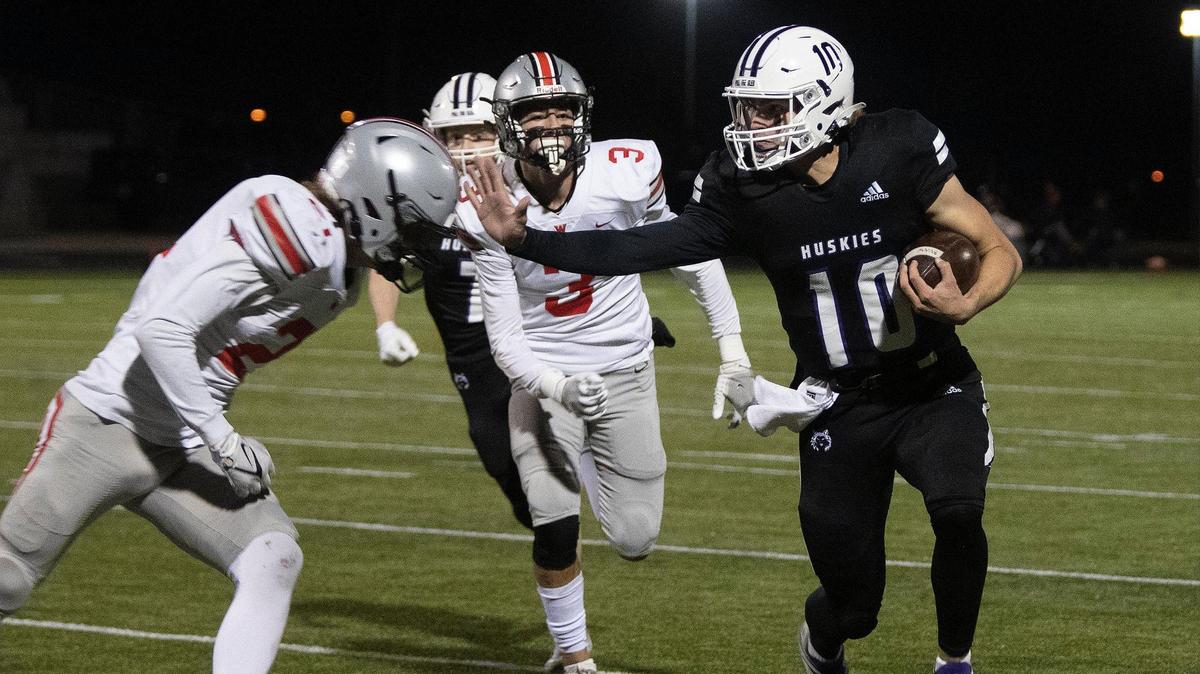 Quarterback Mikey Pauley, #10 of Blue Valley North West fought off the Blue Valley West defense during the game against Blue Valley West Friday, Nov. 19, 2021. Blue Valley Northwest won 35-7 and is headed for the state championship game.
