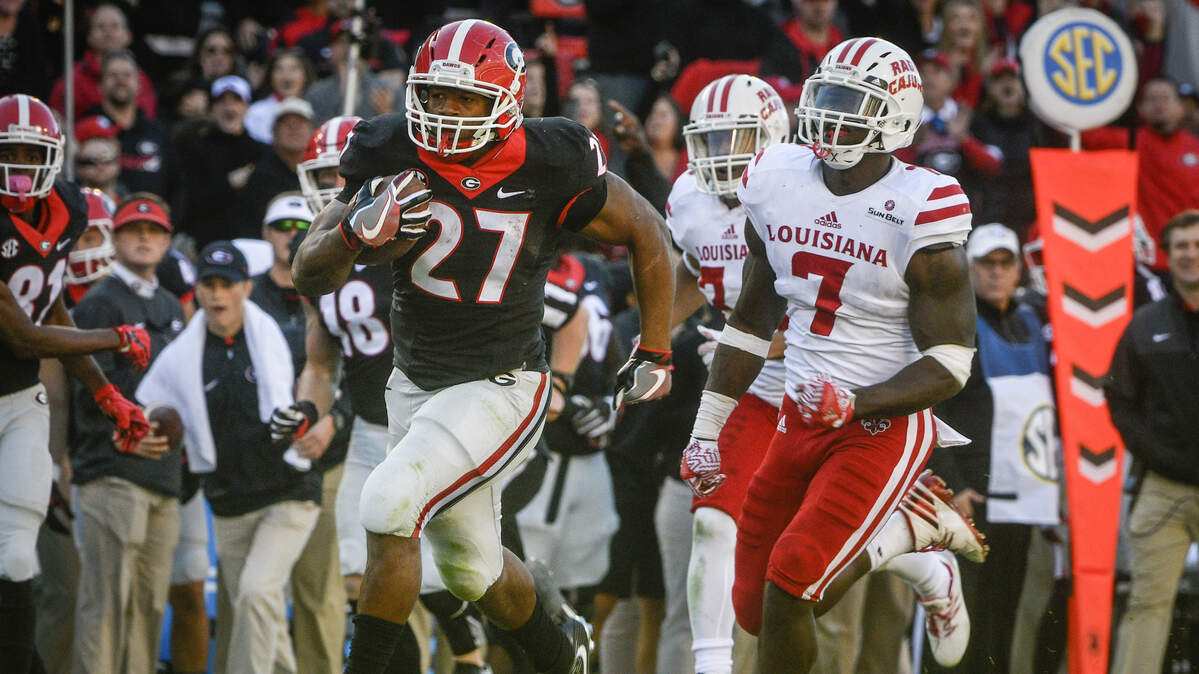 Georgia running back Nick Chubb (27) runs for a touchdown with Louisiana Lafayette linebacker Otha Peters in pursuit during an NCAA college football game, Saturday, Nov. 19, 2016, in Athens, Ga. Peters, now an NFL player, signed with the Kansas City Chiefs on Tuesday.
