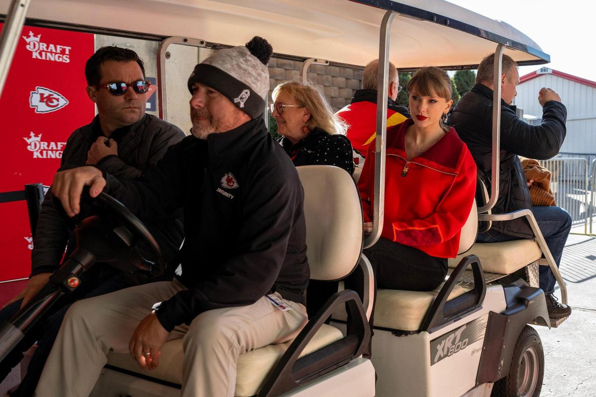 Donna Kelce, left, and pop star Taylor Swift are driven through a tunnel on a golf cart to attend the Kansas City Chiefs’ game against the Las Vegas Raiders on Friday, Nov. 29, 2024, at GEHA Field at Arrowhead Stadium.