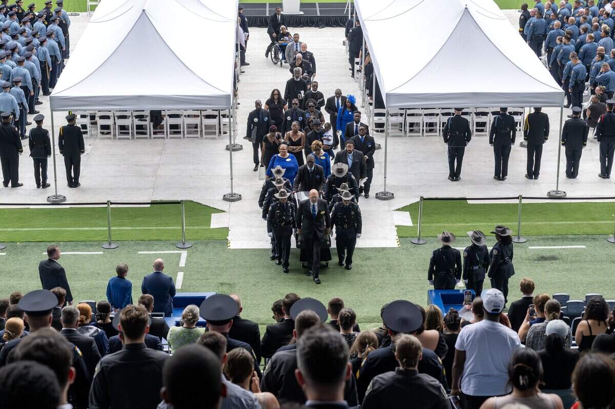 First responders carry Deputy Elijah Ming's casket out of Children's Mercy Park following the funeral service on Monday, Aug. 11, 2025, in Kansas City, Kansas.