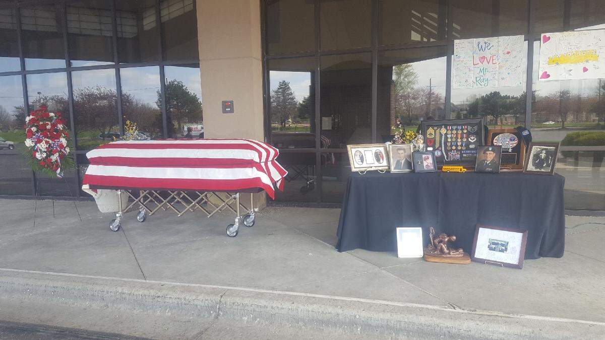 With COVID-19 restrictions on gatherings, the flag-draped casket of Raymond Boler, 72, was placed in the portico of the Overland Park Church of Christ, 13400 W. 119th St., on Sunday so family and friends could drive by and pay their respects.