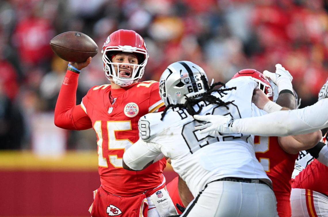 Kansas City Chiefs quarterback Patrick Mahomes (15) throws a pass in the third quarter under heavy defensive pressure from the Las Vegas Raiders on Friday, Nov. 29, 2024, at GEHA Field at Arrowhead Stadium.