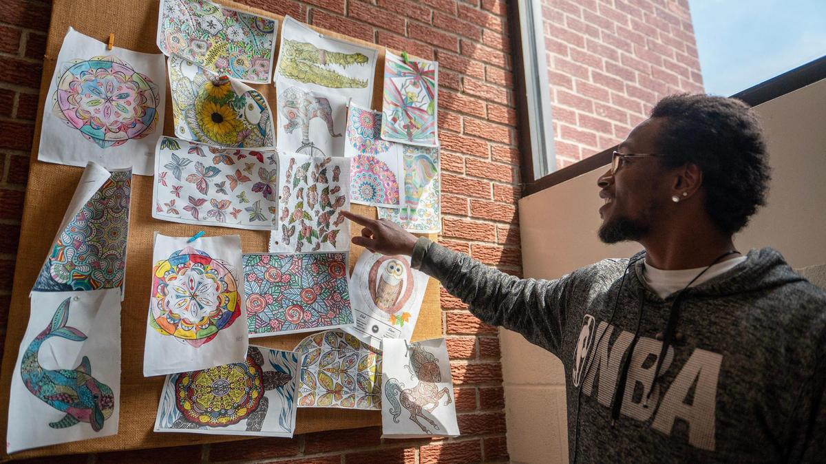 John Tyre Davis, former resident, shares the drawings he made for the L. Minor Care Center on April 25, 2023, in Kansas City.