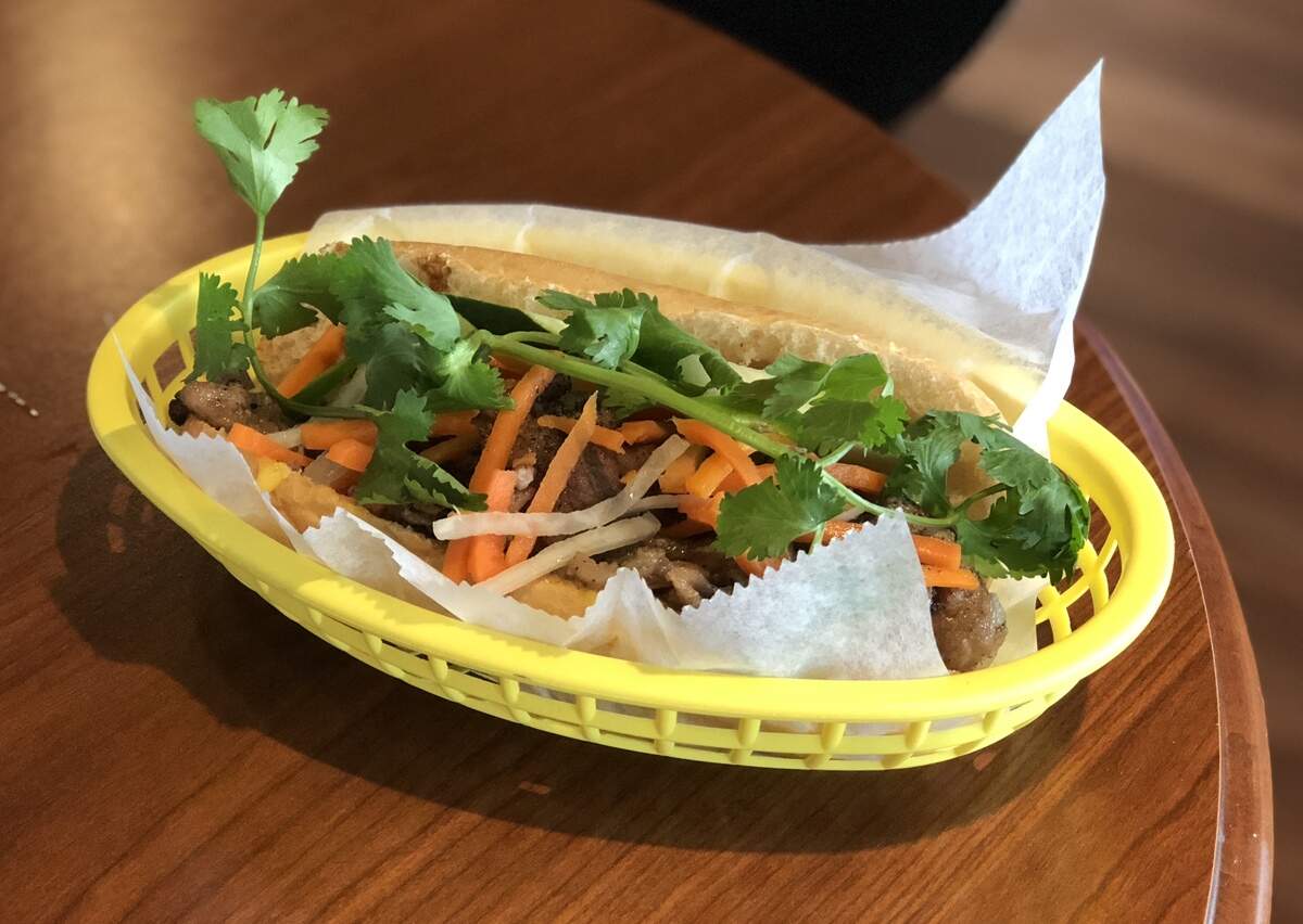 One of the most popular sandwiches at San’s Sandwiches in Gladstone, the $5 BBQ pork sandwich, tops crusty bread stuffed with grilled pork with carrots, jalapeno and fresh cilantro.