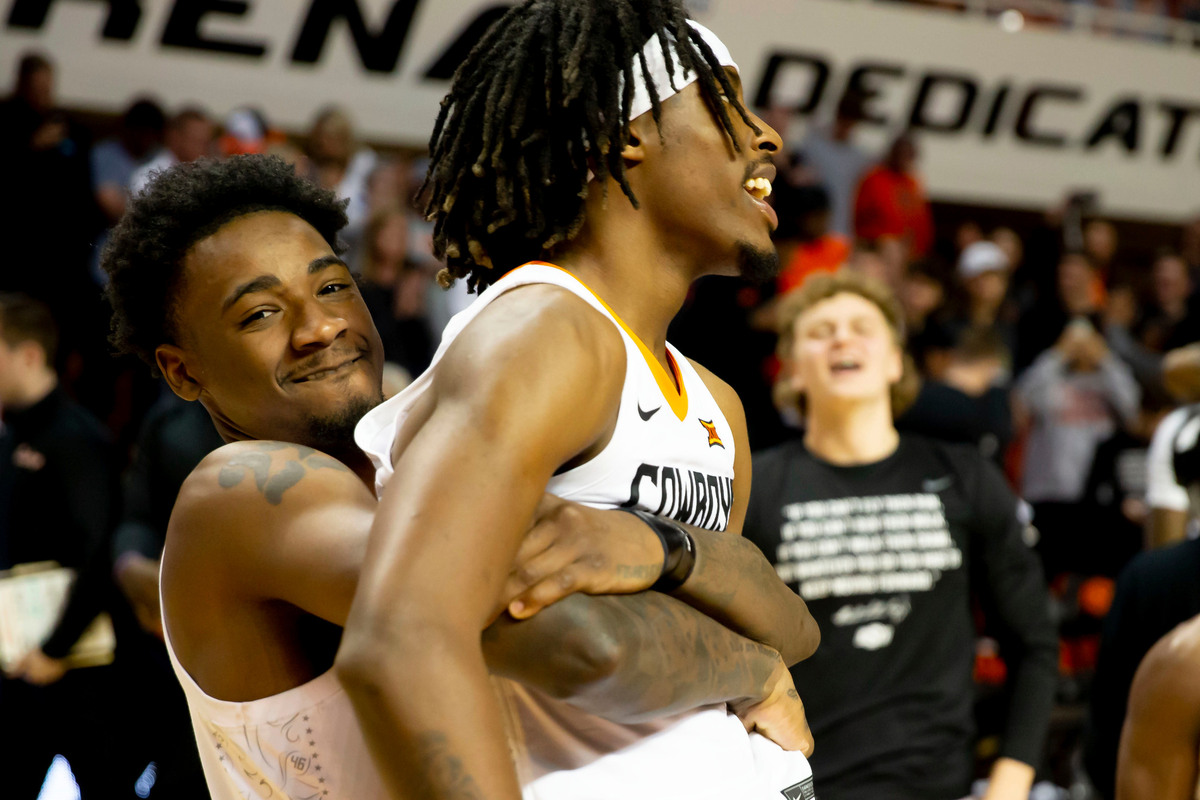 Oklahoma State’s Kalib Boone (left) and Caleb Asberry (right) celebrate after a win against Iowa State in Stillwater, Okla., Saturday, Jan. 21, 2023.