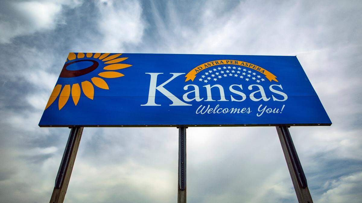 Large sign welcoming drivers to the state of Kansas as they enter the state from Nebraska.