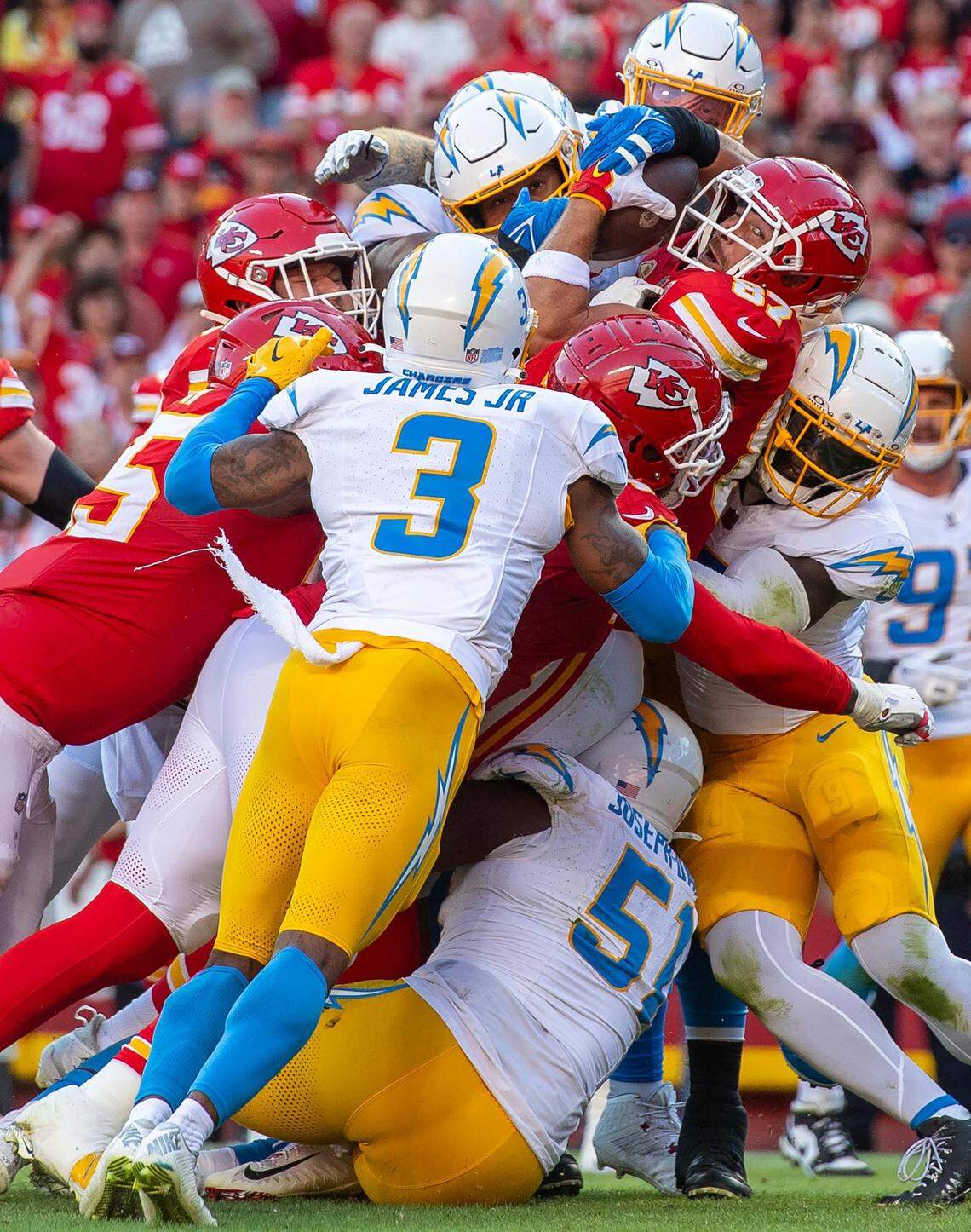 In the fourth frame in the sequence, we see the Charger player’s hands still trying to rip the ball away from Kelce. At this point Kelce has turned his head a tiny bit to his left where we see more of his face. His left eye, perfectly framed by his face mask, is now cocked to the left as if he is trying to spot the goal line.