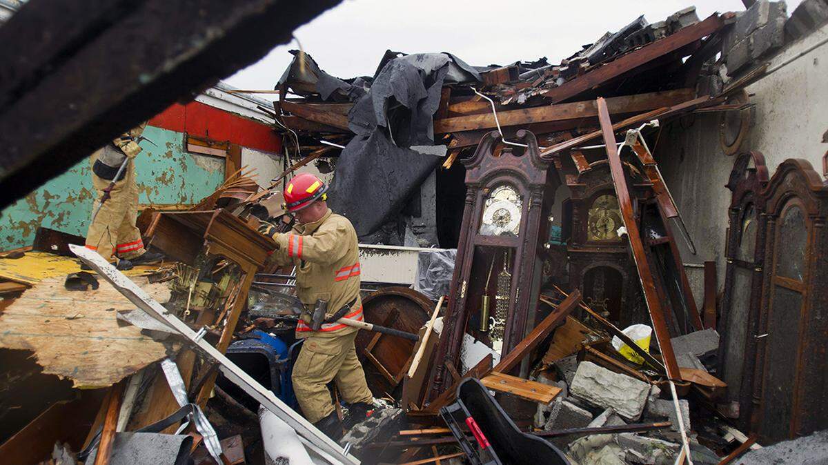 Rob Muir of the Kansas City Fire Department sorted through the ruins of a clock shop on Main Street in Joplin on May 23, 2011.